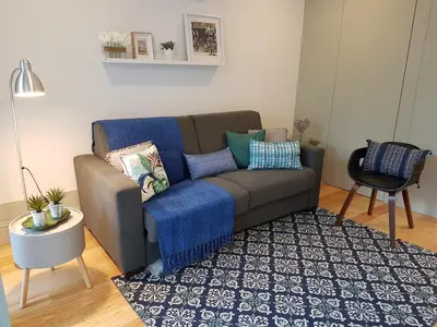 a living room with a couch and a rug at Porto Belo Clérigos in Porto