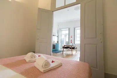 a bedroom with two white towels on a bed at Casa do Poeta & Guitarra by PCH in Porto