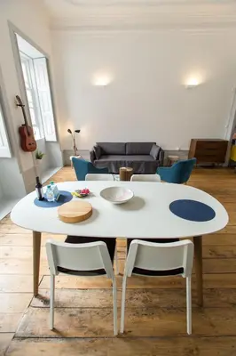 a white table and chairs in a living room at Casa do Poeta & Guitarra by PCH in Porto