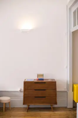 a wooden dresser in a room with a window at Casa do Poeta & Guitarra by PCH in Porto