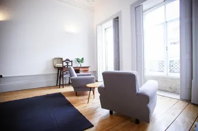 a living room with two chairs and a rug at Casa do Poeta & Guitarra by PCH in Porto
