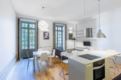 a kitchen and dining room with a table and chairs at Casa Amarela in Porto