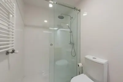 a bathroom with a shower and a toilet at GuestReady - Warm cocoa retreat in Cedofeita in Porto