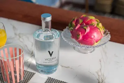 a bottle of water and a bowl of flowers on a table at Victoria Project - Apartments - Private Parking in Porto
