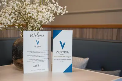 two boxes sitting on top of a table with a vase at Victoria Project - Apartments - Private Parking in Porto