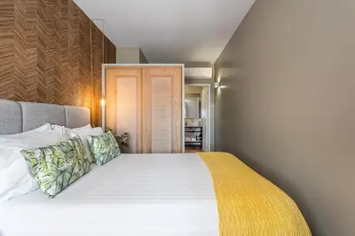 a bedroom with a large white bed with pillows at Victoria Project - Apartments - Private Parking in Porto