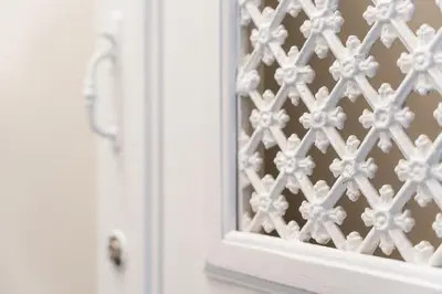 a window with a white lattice pattern on it at Victoria Project - Apartments - Private Parking in Porto
