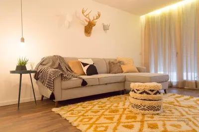a living room with a couch and a rug at Hello Porto Ceuta Residences in Porto