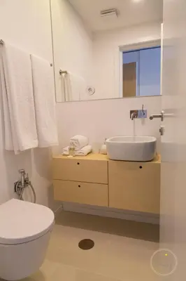 a bathroom with a sink and a toilet and a mirror at Hello Porto Ceuta Residences in Porto