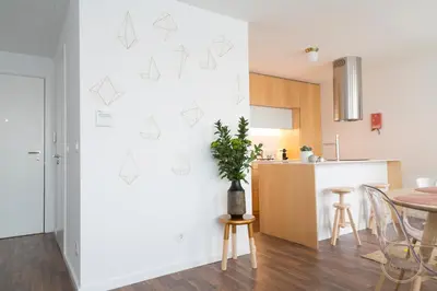 a kitchen and dining room with a plant on the wall at Hello Porto Ceuta Residences in Porto