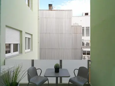 a room with chairs and a table and a window at FLH Porto Central Apartment in Porto