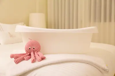 a pink stuffed octopus sitting on top of a bed at Oporto Ceuta Residences - Residence 2 by We Do Living in Porto