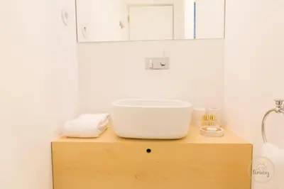 a bathroom with a white bowl on a wooden cabinet at Oporto Ceuta Residences - Residence 2 by We Do Living in Porto
