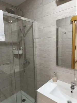 a bathroom with a shower and a sink at Portus Ribeira House in Vila Nova de Gaia