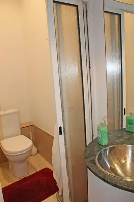 a bathroom with a sink and a toilet at Residencial Paranhos in Porto