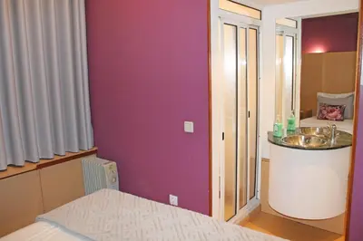 a small bathroom with a sink and a bed at Residencial Paranhos in Porto