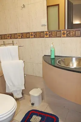 a bathroom with a toilet and a sink at Residencial Paranhos in Porto