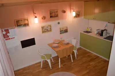 a kitchen with a table and chairs in a room at Rose Green Loft in Porto
