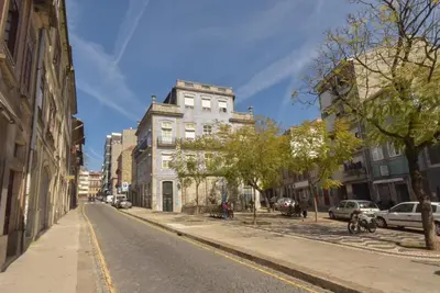 an empty city street with a tall white building at Rose Green Loft in Porto