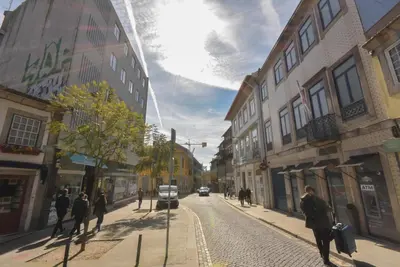 a group of people walking down a city street at Rose Green Loft in Porto