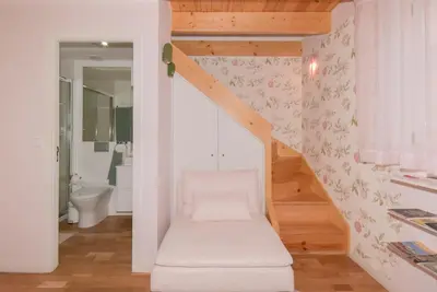 a room with a staircase with a toilet and a bathroom at Rose Green Loft in Porto