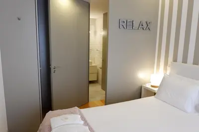 a bedroom with a white bed and a mirror at Porto Urban Art Trindade in Porto