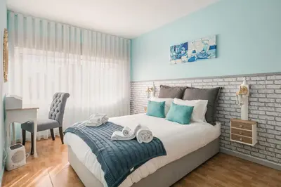 a bedroom with a bed with towels on it at Camarinha Oporto Apartments in Porto