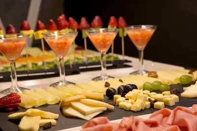 a table with wine glasses and cheese and fruit at Apartamentos The Arc Carrís in Porto