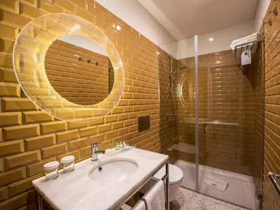 a bathroom with a sink and a mirror at Apartamentos The Arc Carrís in Porto