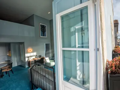 a balcony with a view of a room with a window at Apartamentos The Arc Carrís in Porto