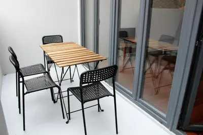 a table and chairs on a balcony with a table at Bonjardim Flats - T2 com Varanda in Porto