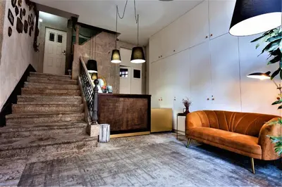 a living room with a staircase and a couch at YOUROPO - Taipas in Porto