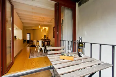 a balcony with a table with a bottle of wine at Porto Emotions - Caldeireiros in Porto