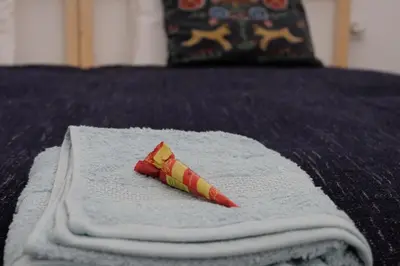 a napkin with a wrapper on top of a bed at Bonjardim Flats - T1 + 1 com terraço in Porto