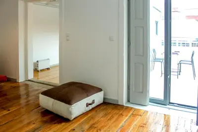 a ottoman sitting on the floor in an empty room at Bonjardim Flats - T1 + 1 com terraço in Porto
