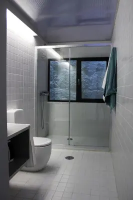 a bathroom with a shower and a toilet and a window at Bonjardim Flats - T1 + 1 com terraço in Porto