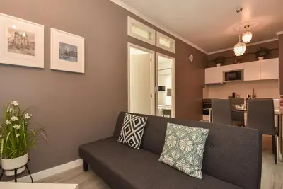 a living room with a couch and a kitchen at Oporto Batalha Residence free parking in Porto