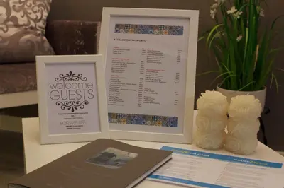 a table with a menu and a book on a table at Oporto Batalha Residence free parking in Porto