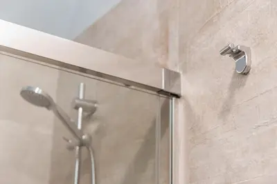 a shower with a glass door with a shower head at GuestReady - Chic retreat in the heart of Porto in Porto