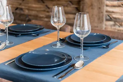 a table topped with black plates and wine glasses at GuestReady - Chic retreat in the heart of Porto in Porto