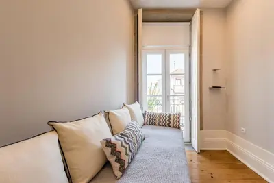 a living room with a couch and a window at GuestReady - Chic retreat in the heart of Porto in Porto