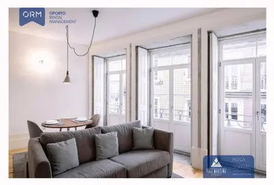 a living room with a couch and two windows at ORM - 3 C´s Apartments in Porto