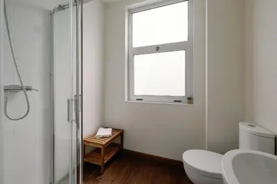 a bathroom with a toilet and a window at Cosme Apartments by Olala Homes in Porto