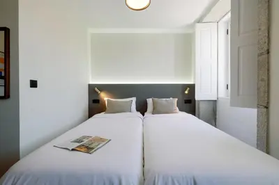 two beds sitting next to each other in a room at Cosme Apartments by Olala Homes in Porto