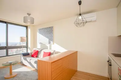 a living room with a couch and a table at Liiiving in Porto | Downtown View Apartment in Porto