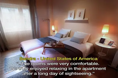 a hotel room with two beds and a table at LivingPorto Boavista in Porto