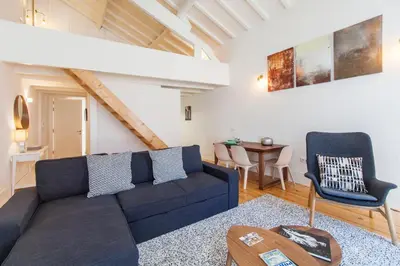 a living room with a blue couch and a table at Oporto Mezzanine - by ML Apartments in Porto