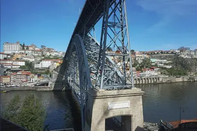 a bridge over a river with a city in the background at Porto View by Patio 25 in Vila Nova de Gaia