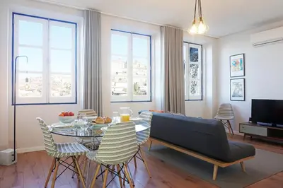 a living room with a table and chairs at Porto View by Patio 25 in Vila Nova de Gaia