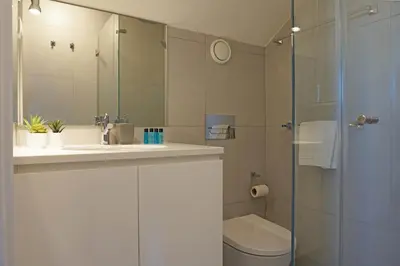 a bathroom with a sink and a toilet and a shower at Porto View by Patio 25 in Vila Nova de Gaia